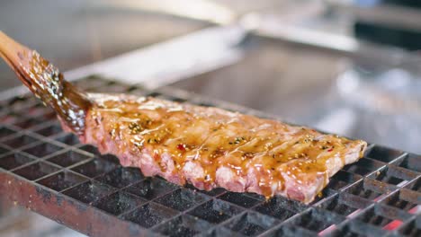 Chef-preparing-pork-ribs-on-grill