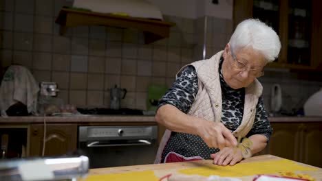 Senior-woman-cooking-tortellini-at-home
