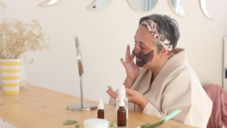 Woman-applying-mask-on-face