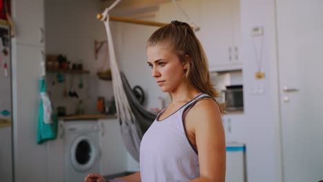Woman-with-resistance-band-on-wrists-working-out-at-home