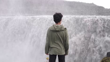 Traveling-man-enjoying-freedom-near-waterfall