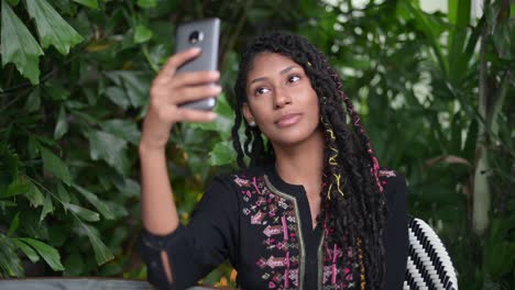 Afro-latina-woman-taking-a-selfie-in-restaurant