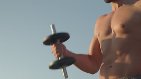 Anonymous-muscular-man-exercising-with-dumbbells