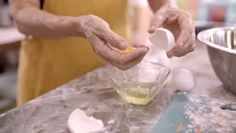 Crop-woman-separating-egg-yolk-from-white-in-kitchen