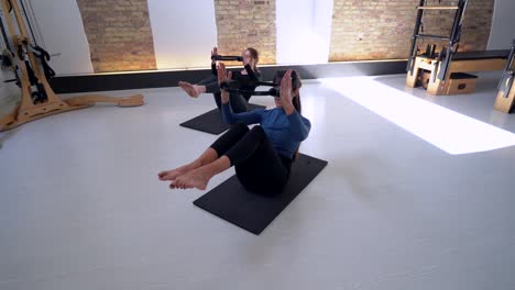 Women-doing-exercises-with-pilates-ring-in-studio