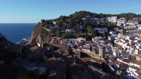 Coastal-town-with-small-houses-and-old-tower-on-rocky-cliff