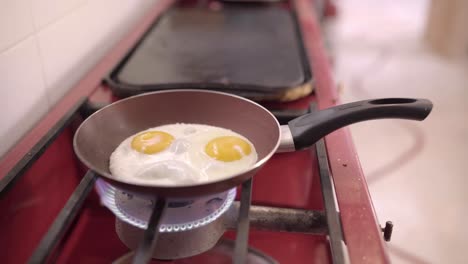 Person-frying-eggs-on-pan