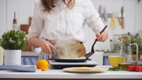 Cook-flipping-a-pancake-in-the-frying-pan