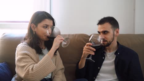 Smiling-couple-with-wineglasses-at-home