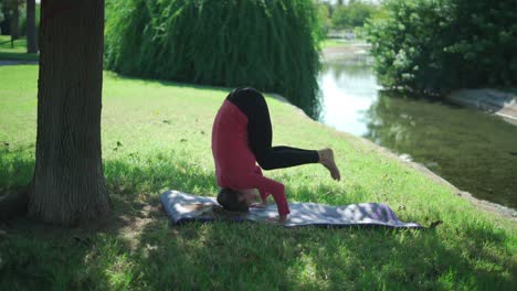 Woman-practicing-Supported-headstand-in-park