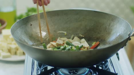 Woman-frying-mushrooms-and-vegetables-in-pan