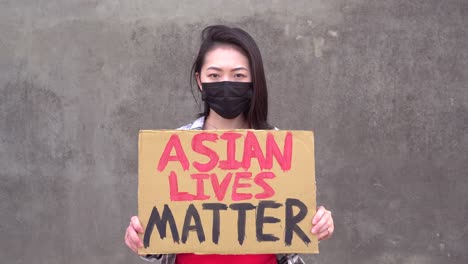 Mujer-Asiática-Con-Cartel-Durante-La-Protesta-Contra-El-Acoso-Sexual.