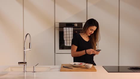Frau-Chattet-Auf-Dem-Smartphone-In-Der-Küche