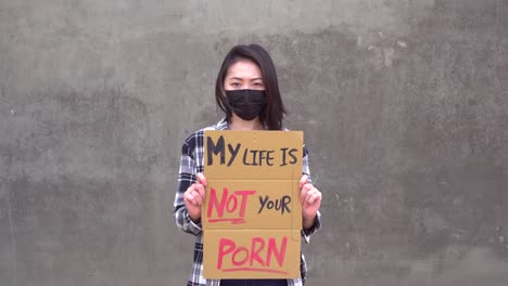 Asian-woman-with-poster-during-protest-against-sexual-harassment