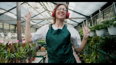 Nature's-Dance:-A-Joyful-Journey-Through-a-Flower-Shop.-A-girl-in-a-green-apron-is-a-happy-employee-of-flower-shops-dancing-in