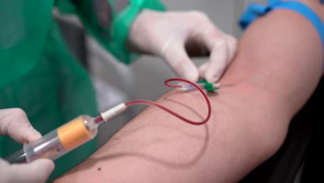 Crop-doctor-taking-blood-from-vein-of-patient