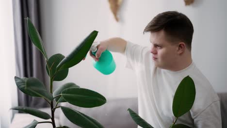 Man-with-down-syndrome-spraying-houseplants-with-care