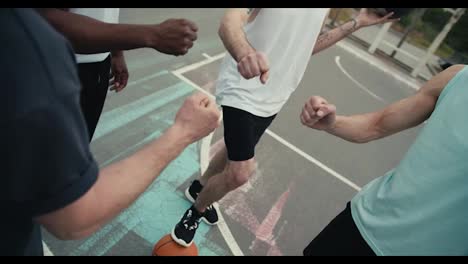 Close-up-shot-of-basketball-players-playing-Rock-Paper-Scissors-to-determine-the-team-that-will-play-the-ball-first