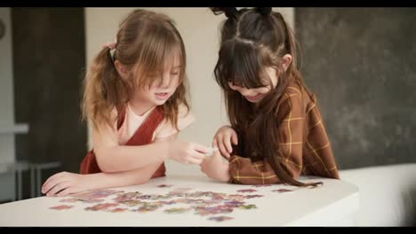 Two-diverse-children-playing-puzzles-at-home