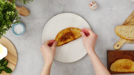 Crop-person-preparing-avocado-toast-for-breakfast-in-kitchen