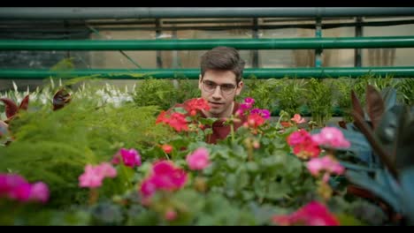 xploring-the-Beauty-of-Nature:-A-Young-Man's-Passion-for-Flowers.-A-young-guy-examines-a-large-number-of-flowers-and-greenery-in