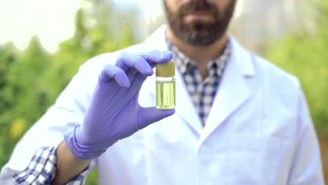Focused-scientist-showing-cannabis-pill