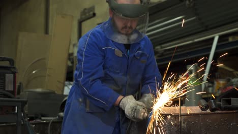Workman-welding-metal-construction-in-workshop