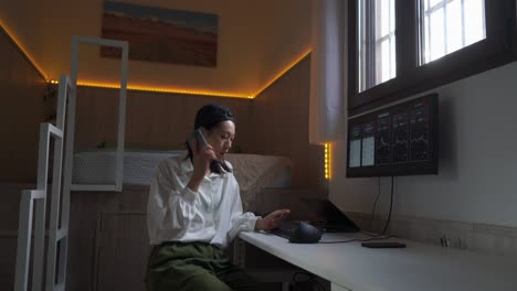 Ethnic-woman-having-phone-during-remote-work-with-cryptocurrency