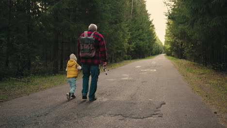 happy-weekend-of-grandfather-and-his-little-grandson-old-man-and-little-boy-are-walking-to-fishing