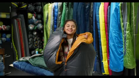 Closeup-of-a-woman-covered-in-sleeping-bag-at-tourist-store