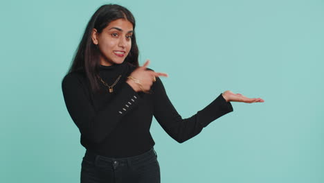 Indian-woman-showing-thumbs-up-pointing-empty-place,-advertising-area-for-commercial-text-copy-space