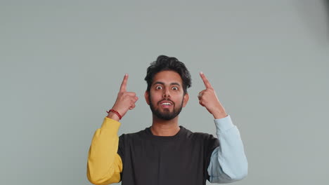 Indian-man-showing-thumbs-up-pointing-empty-place,-advertising-area-for-commercial-text,-copy-space