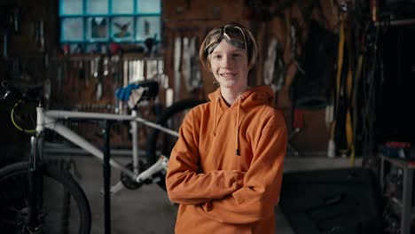 The-Precision-of-Modern-Manufacturing:-A-Teenager's-Expertise.-A-teenager-in-goggles-and-an-orange-sweatshirt-poses-against-the