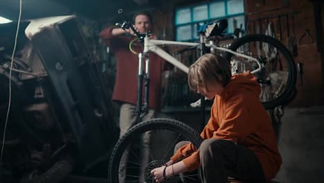 Trabajo-En-Equipo-De-Padre-E-Hijo-En-Taller-De-Reparación-De-Bicicletas