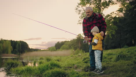 happy-little-boy-is-spending-time-with-granddad-grandpa-is-teaching-grandson-to-fish