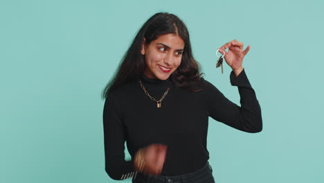 Indian-woman-real-estate-agent-showing-keys-of-new-home-house-apartment,-buying-renting-property