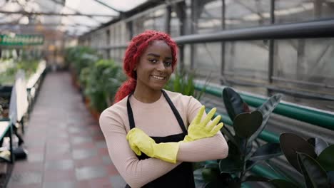Portrait-of-young-multiethnic-woman-looking-to-camera,-posing-while-standing-in-greenhouse