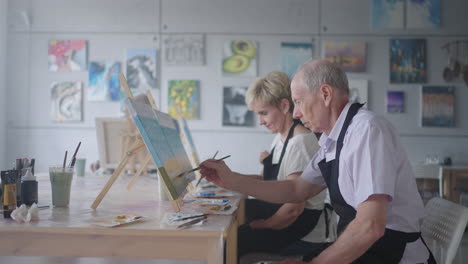 Slow-motion-Old-people-attend-drawing-courses.-The-teacher-helps-pensioners-who-attend-drawing-courses-to-draw.-A-group-of-retired-friends-at-a-drawing-lesson