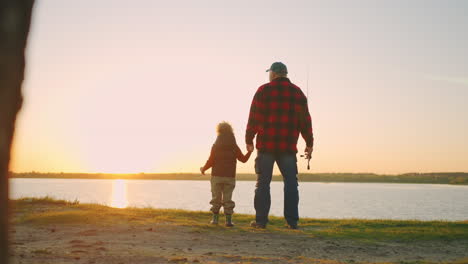 cute-toddler-and-his-grandfather-are-amazing-beautiful-sunset-on-river-or-lake-old-man-and-grandson