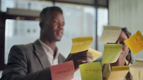 brainstorming-in-marketing-department-of-big-company-african-persons-are-sticking-post-it-notes