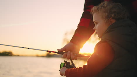 little-boy-is-spending-weekend-with-dad-or-grandpa-in-nature-child-is-fishing-by-rod