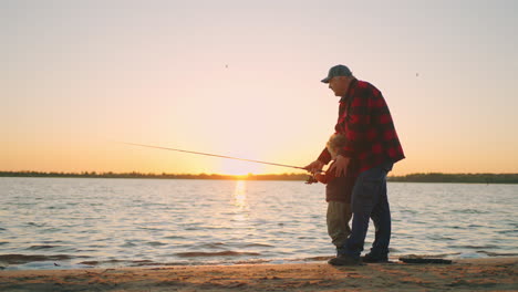 happy-little-boy-with-grandfather-on-fishing-family-is-spending-weekend-on-shore-of-river-or-lake
