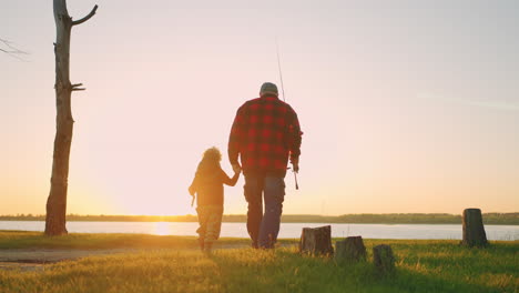 idyllic-scene-with-old-man-and-his-grandson-walking-to-river-for-fishing-rear-view-happy-childhood-and-old-age