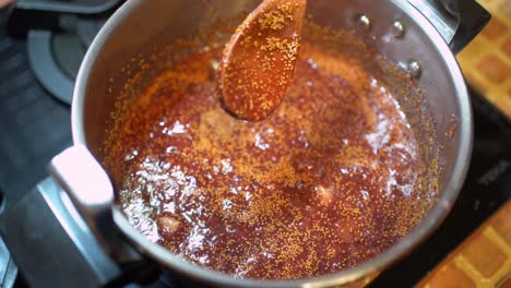 Crop-person-preparing-fig-jam-in-pressure-cooker-in-kitchen