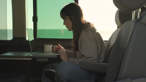 Traveling-woman-working-on-laptop-in-van