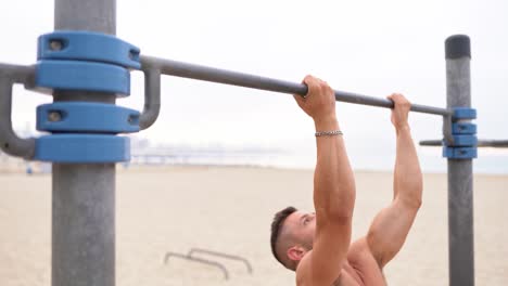 Fit-sportsman-doing-pull-ups-on-bar