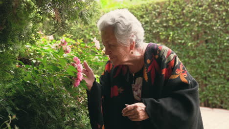 Senior-female-with-roses-in-garden
