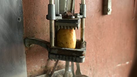 Crop-cook-using-potato-cutter-for-preparing-French-fries