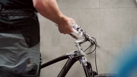 Crop-man-cleaning-gear-cassette-of-bike-wheel
