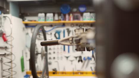 Mechanic-centering-bike-wheel-on-truing-stand